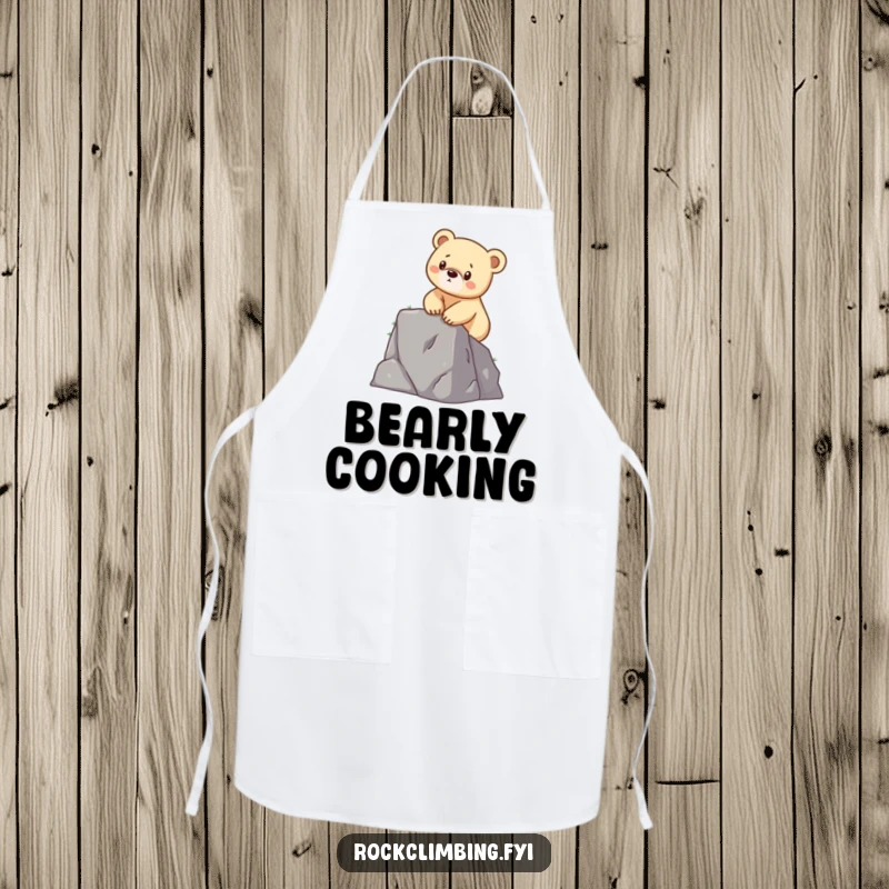 Funny apron with a determined bear cub scaling a small cliff, ideal for kitchen or workshop adventures.