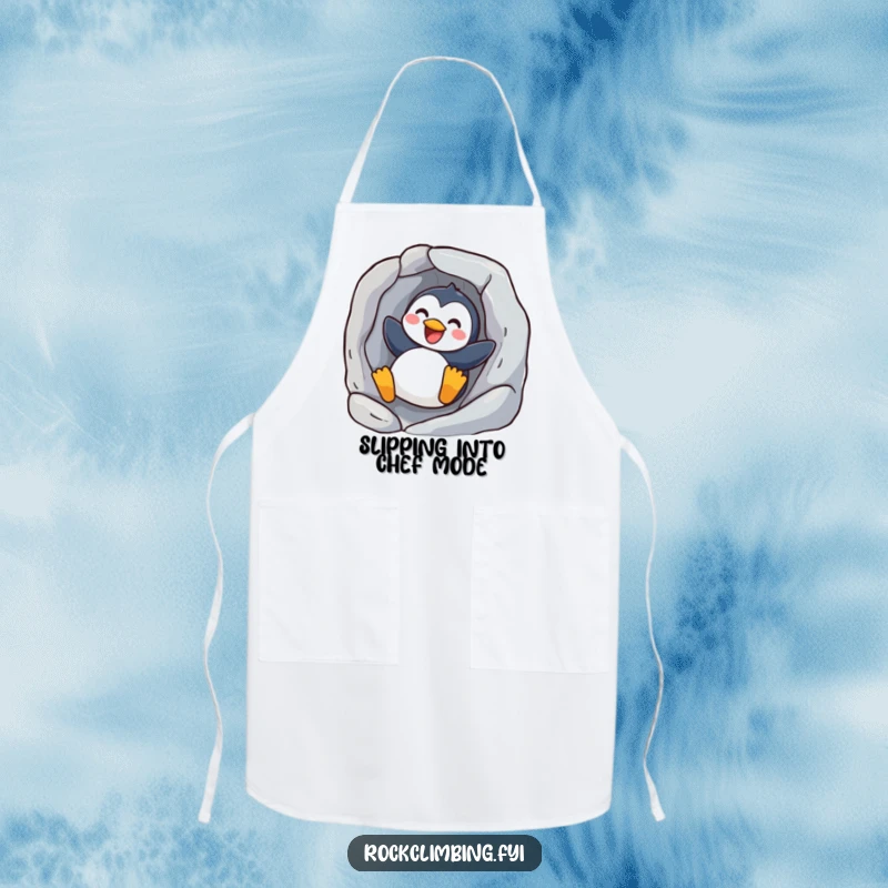 Funny joyful penguin apron showing a happy bird sliding down a rock, perfect for cooking or baking with a cheerful spirit.