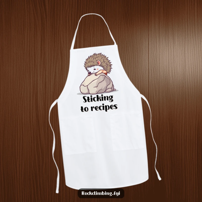 Tiny hedgehog using suction cups to climb a smooth boulder, on a practical kitchen apron.