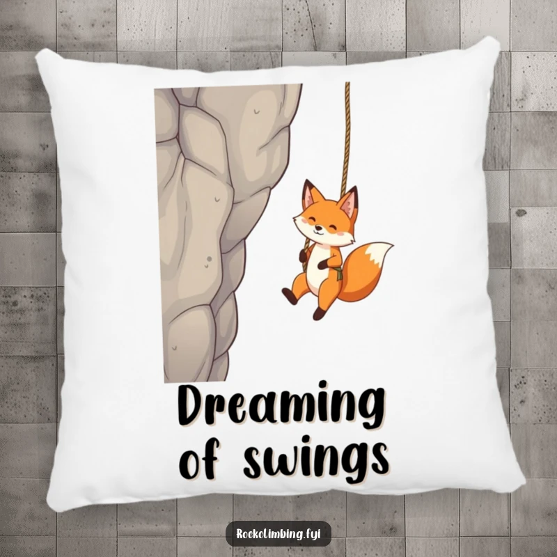 Funny Fox Pillow: A playful fox is shown dangling from a rope swing by a tall crag, offering comfort and fun.
