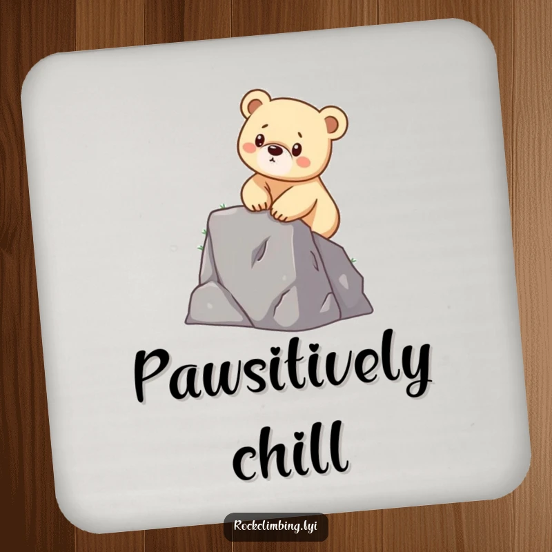 Funny drink coaster depicting a determined bear cub scaling a small cliff, adding inspirational and humorous decor.