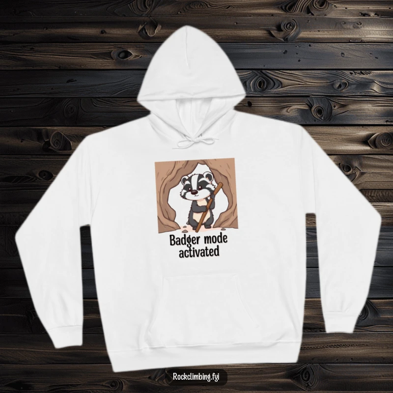 Funny badger hoodie showing a determined badger using a stick to find pawholds on a climb, embodying grit and humor.