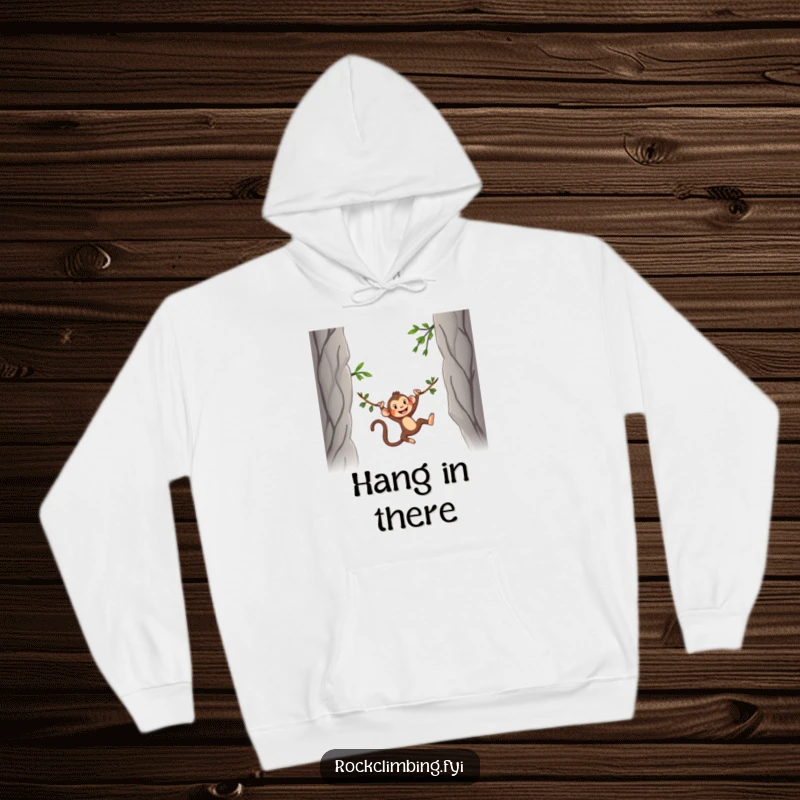 Funny Hoodie designed with a silly monkey swinging energetically on a vine between two rocky mountain peaks, offering warmth and fun.