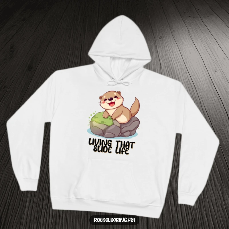 Funny otter hoodie depicting a cheerful otter joyfully sliding down a wet, mossy rock, radiating happiness and playful spirit.