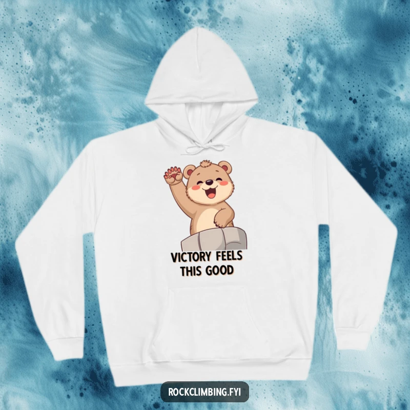 Funny bear cub hoodie, showing a joyful cub cheering from a high ledge with paws raised, embodying pure exhilaration and comfort.