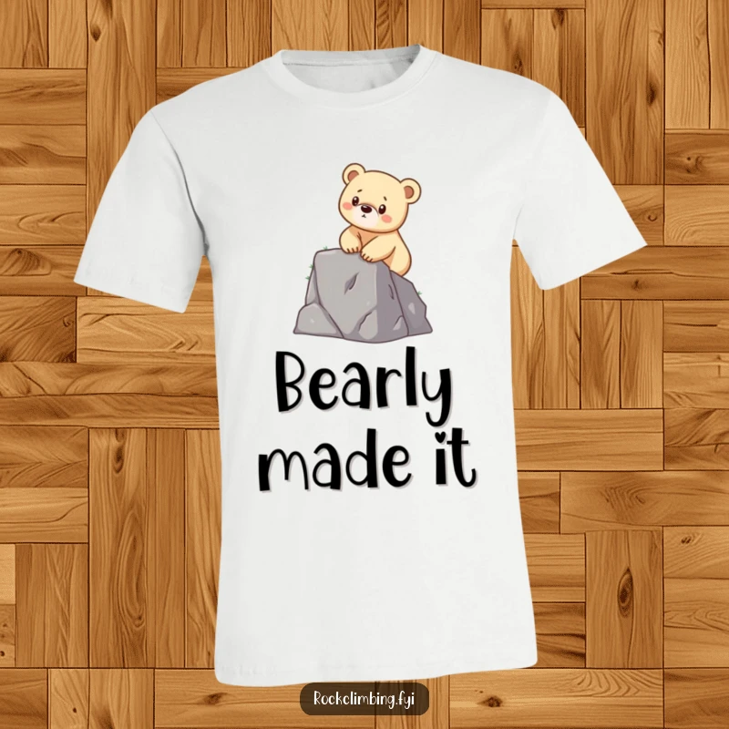 Funny t-shirt graphic of a determined bear cub scaling a small cliff with its tiny paws, showcasing courage and effort.
