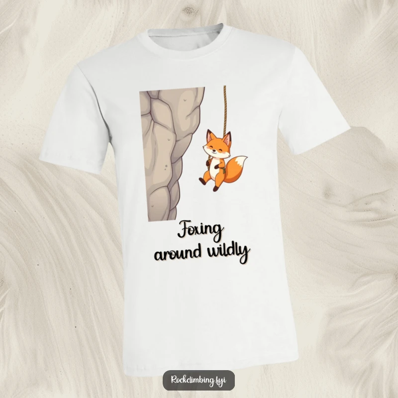 Funny Fox T-Shirt: A playful fox swings daringly from a rope attached to a crag, exuding carefree joy and adventure.