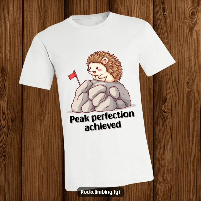 Funny t-shirt with a happy hedgehog carefully planting a small flag on a rocky summit, celebrating a cute and hilarious achievement.