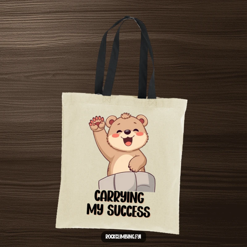 Funny bear cub tote bag, depicting a joyful cub exuberantly cheering from a high ledge with paws raised high in celebration.