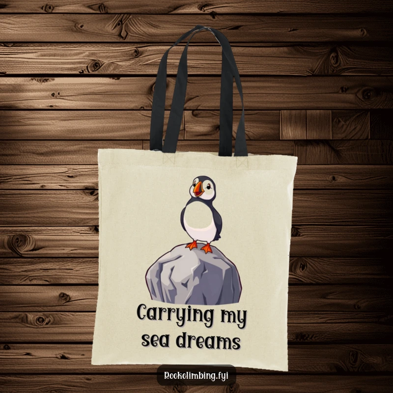 Funny tote bag featuring a delighted puffin perched on a rock, gazing at the sea, embodying a cheerful and humorous coastal theme.