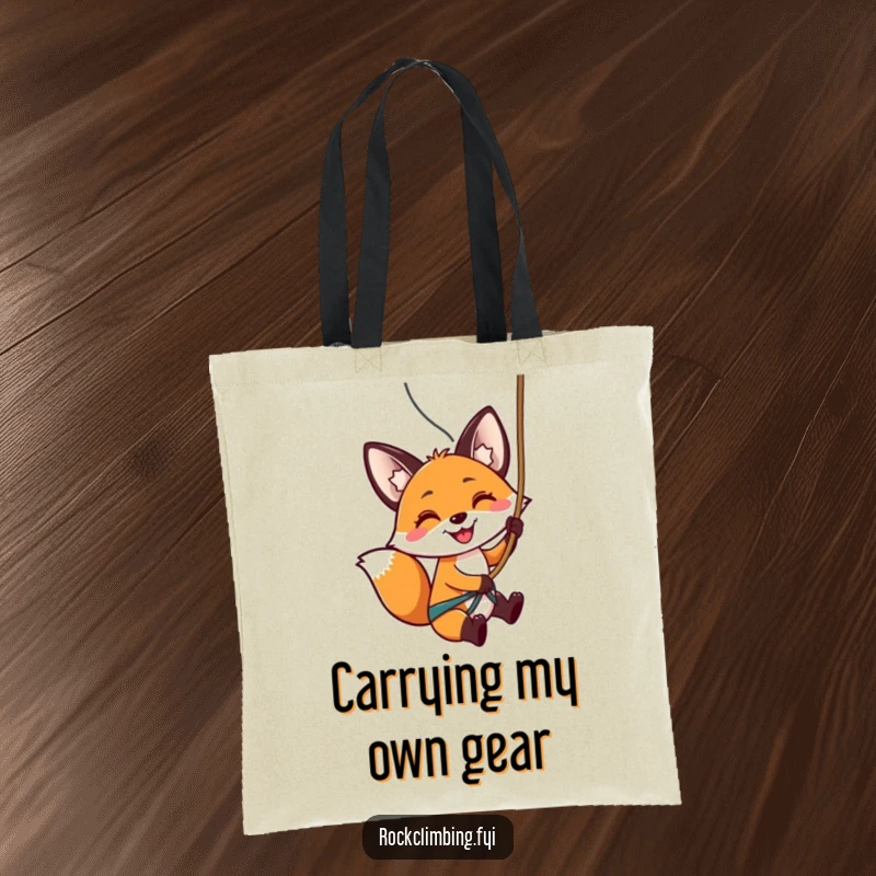 Funny tote bag with a smiling fox rappelling down a rock face, ready for excitement and exploration.