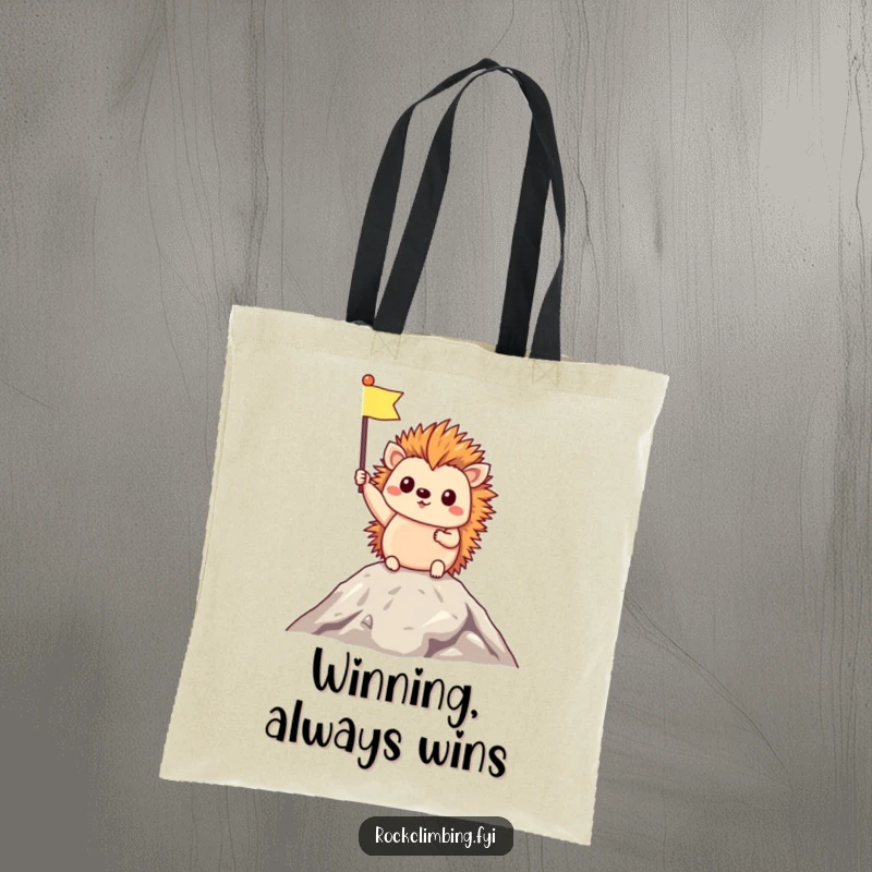 Funny Tote Bag depicting a triumphant hedgehog holding a tiny flag at the very top of a mountain, celebrating success and adventure.